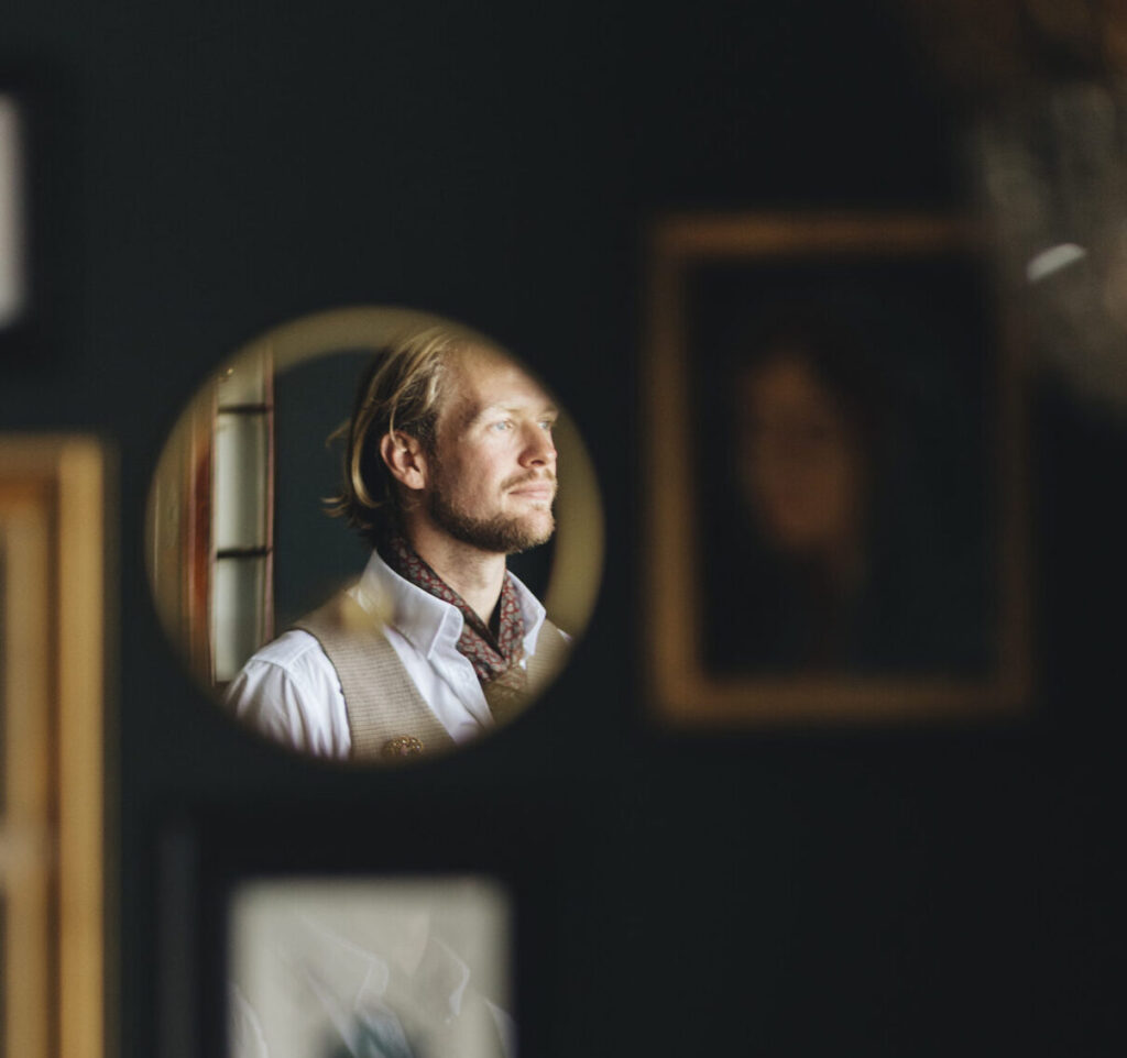 Foto van Bernhard's reflectie in een spiegel aan een muur